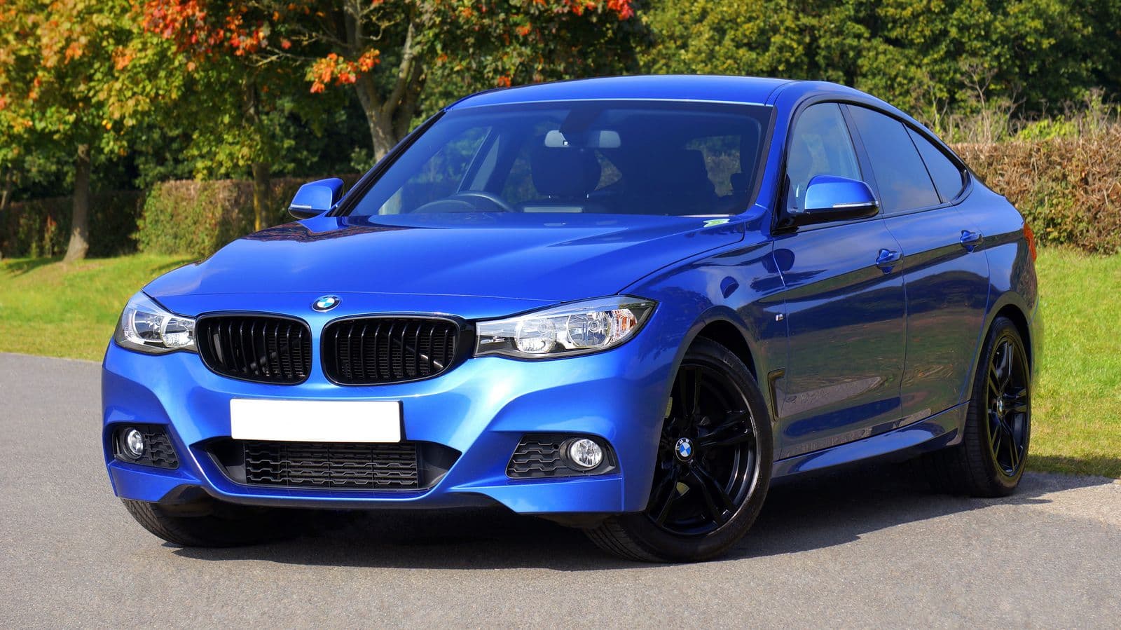 A blue hatchback parked on a driveway